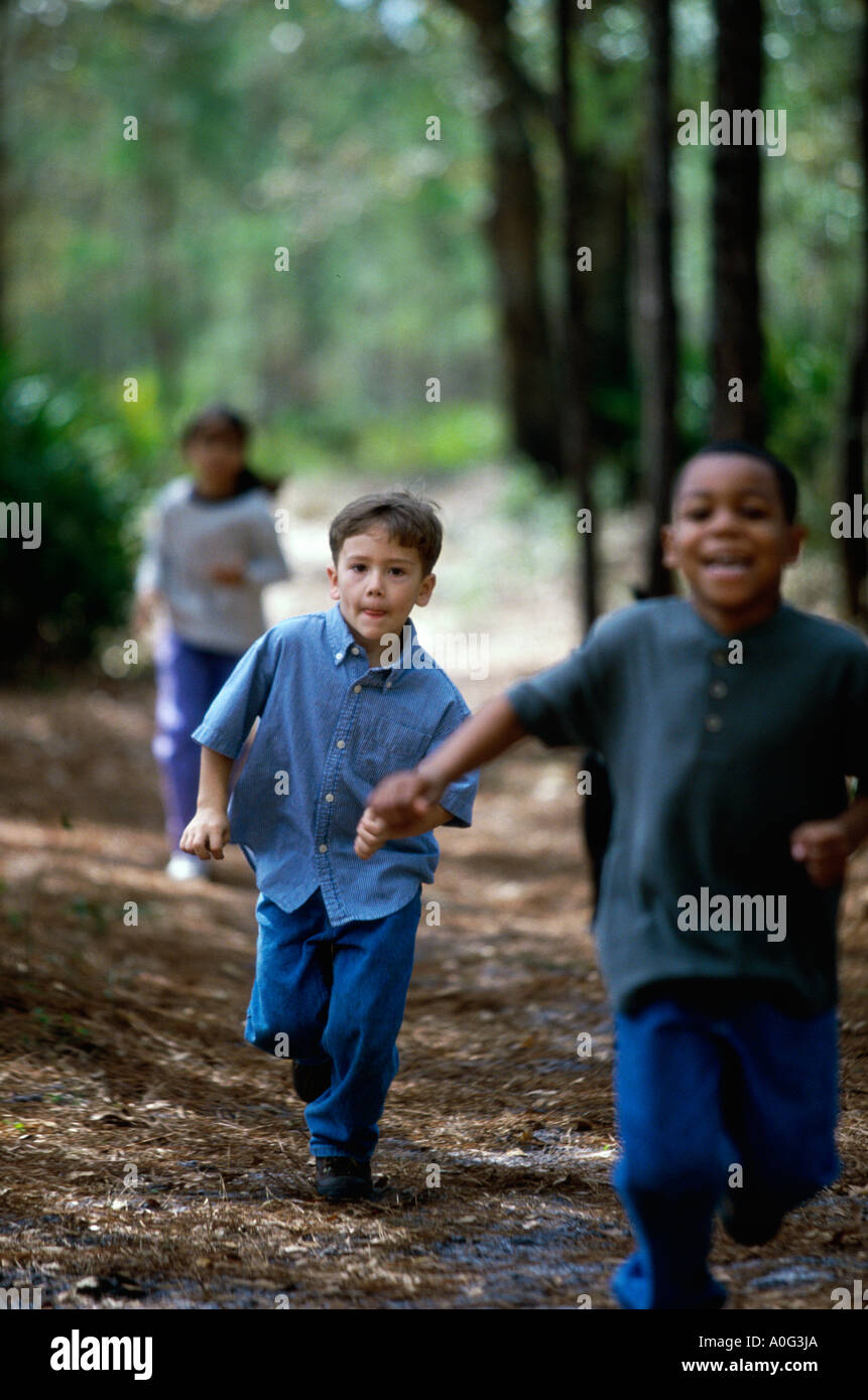 Two children holding hands running down hi-res stock photography and ...