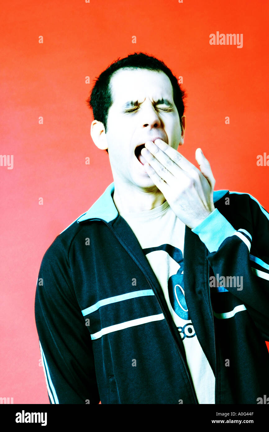 Young man yawning Stock Photo