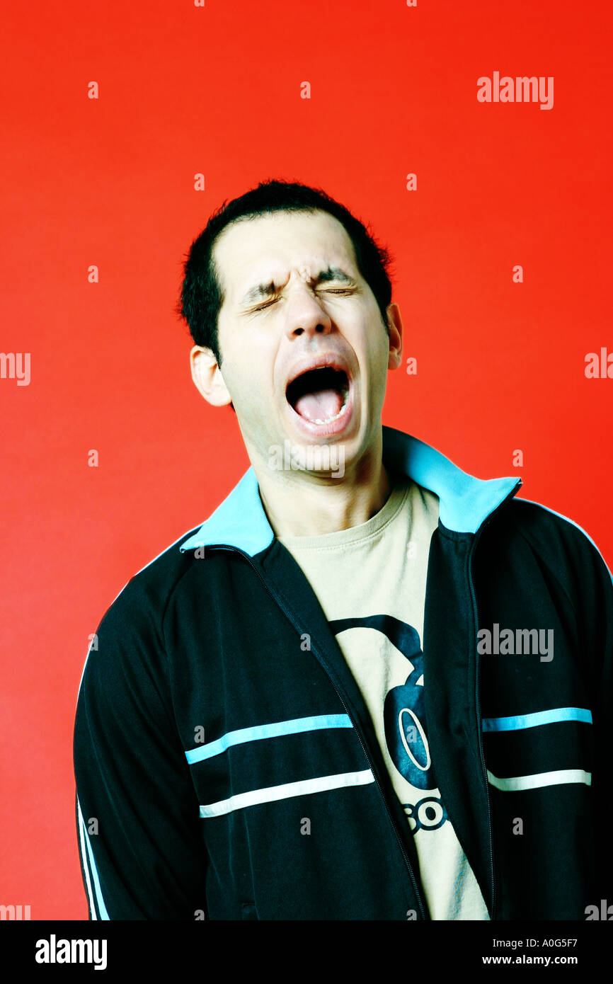 Young man yawning Stock Photo