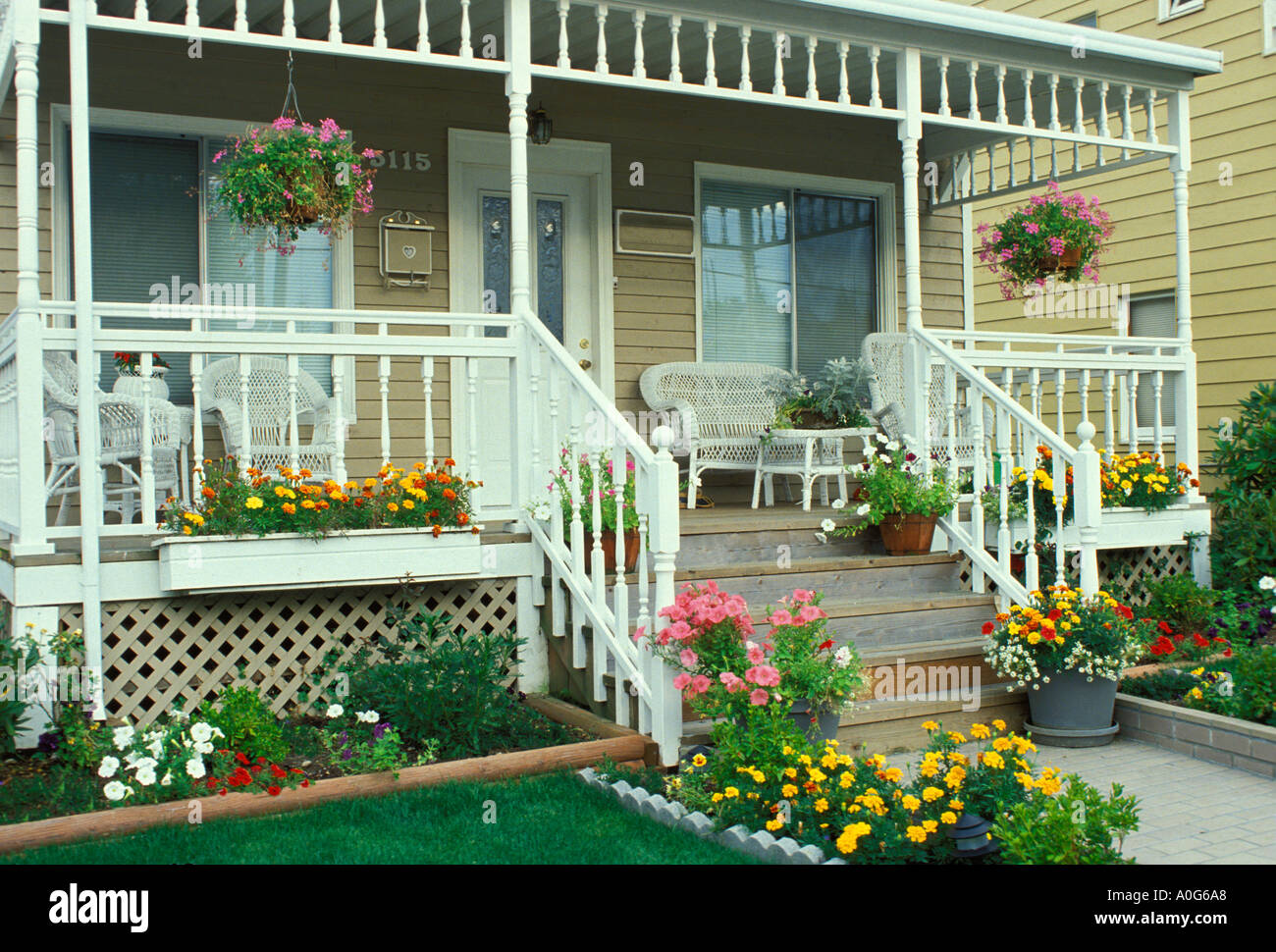 Front porch of traditional house with brick steps and furniture