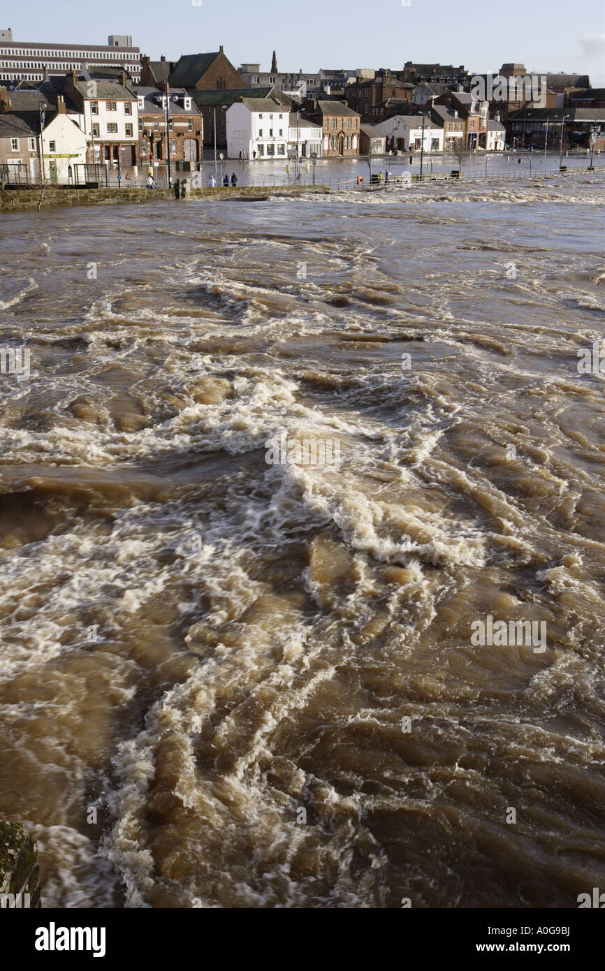 The raging torrent of the River Nith in flood looking across to flooded houses and businesses possible insurance claims UK Stock Photo