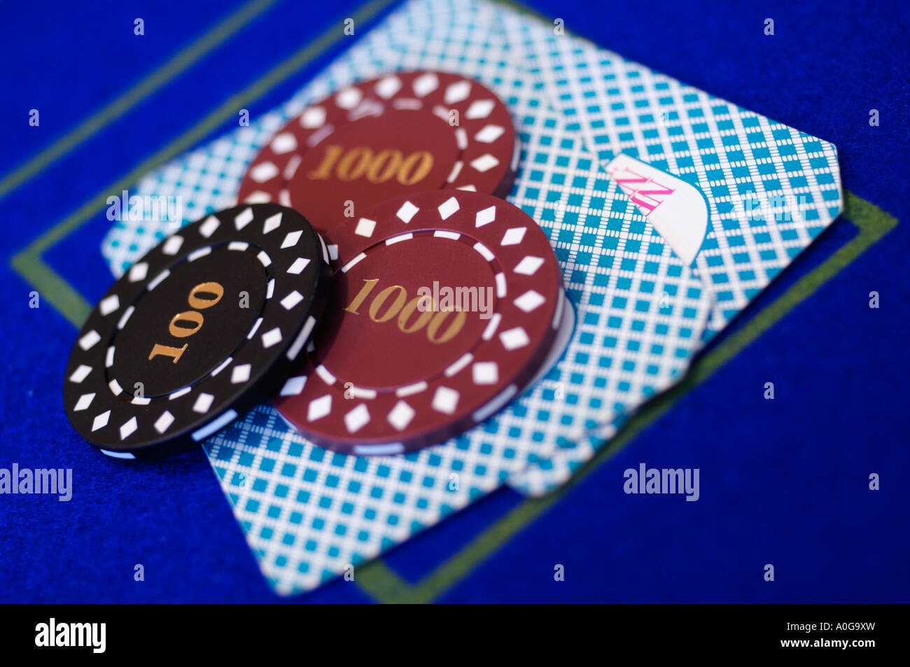 Chips placed on pair of cards on card table Stock Photo
