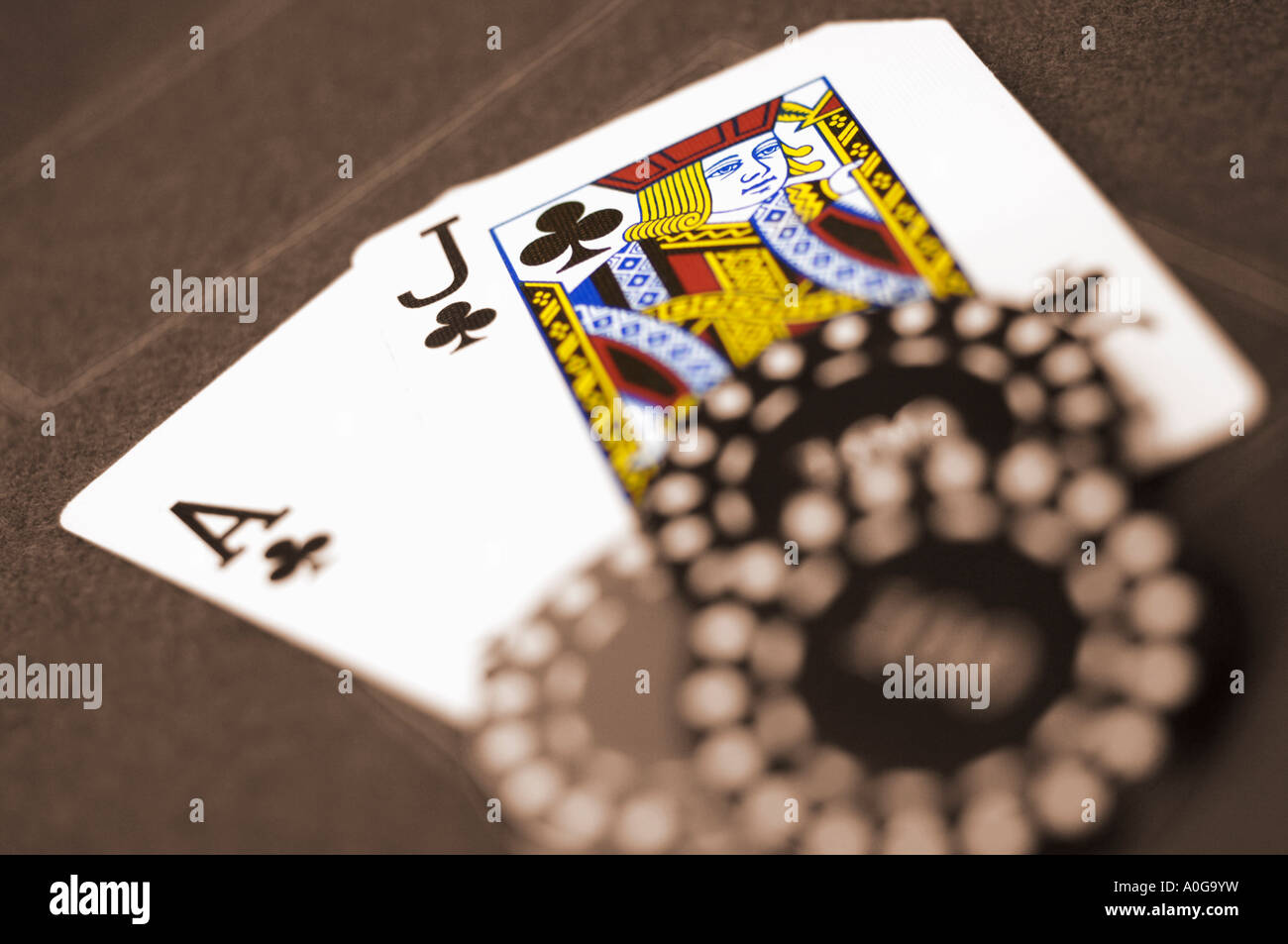 Chips on ace and jack on card table sepia toned with spot colour Stock Photo