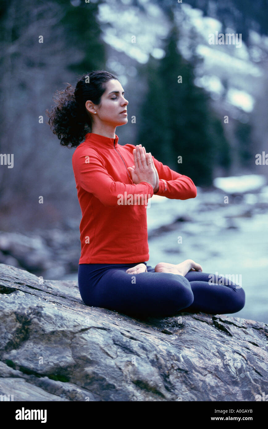Young woman meditating in the lotus position Stock Photo
