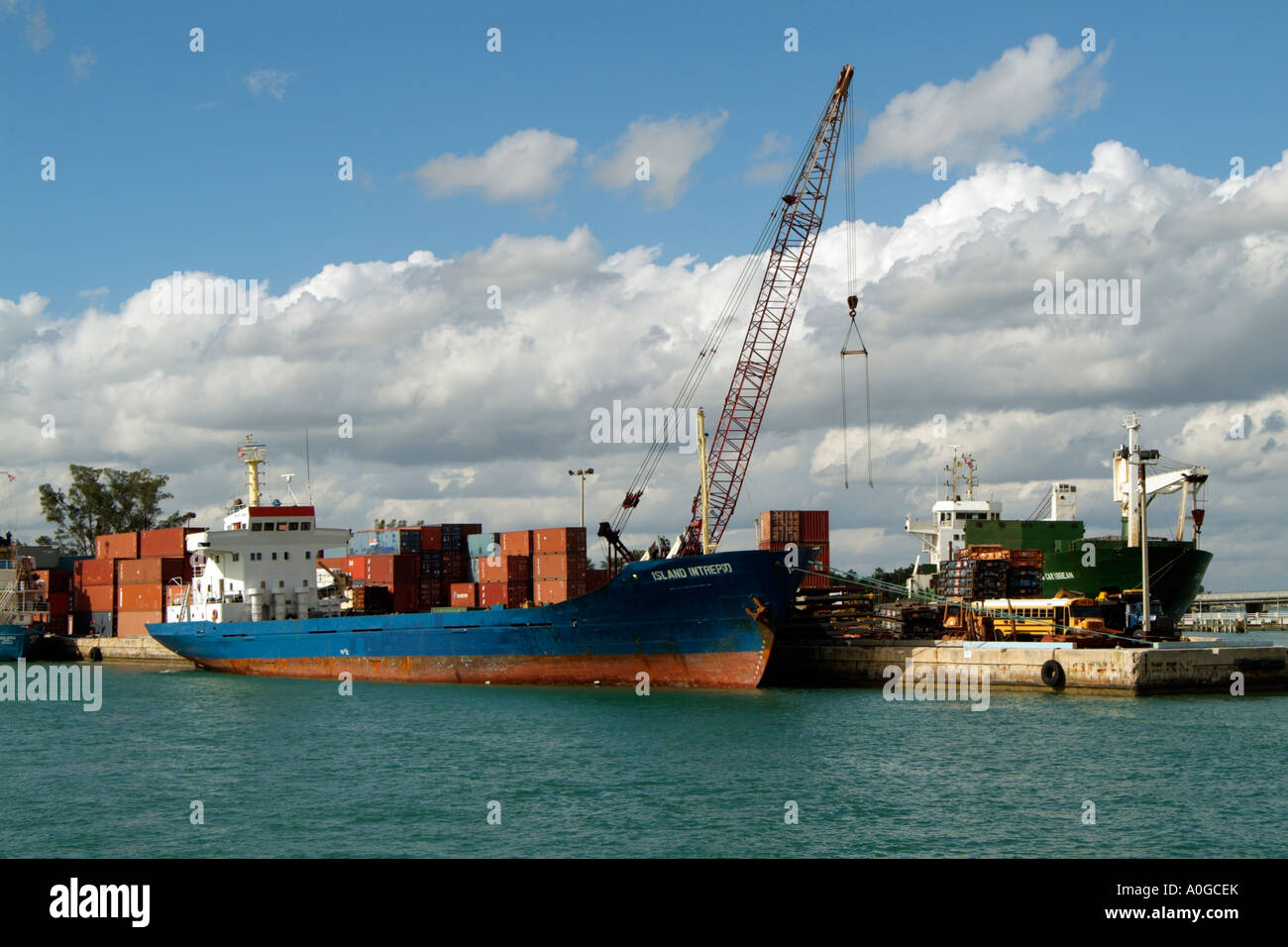 Container ship The Island Intrepid which sails under the flag of Saint Vincent and The Grenadines loading in the Port of Miami Stock Photo