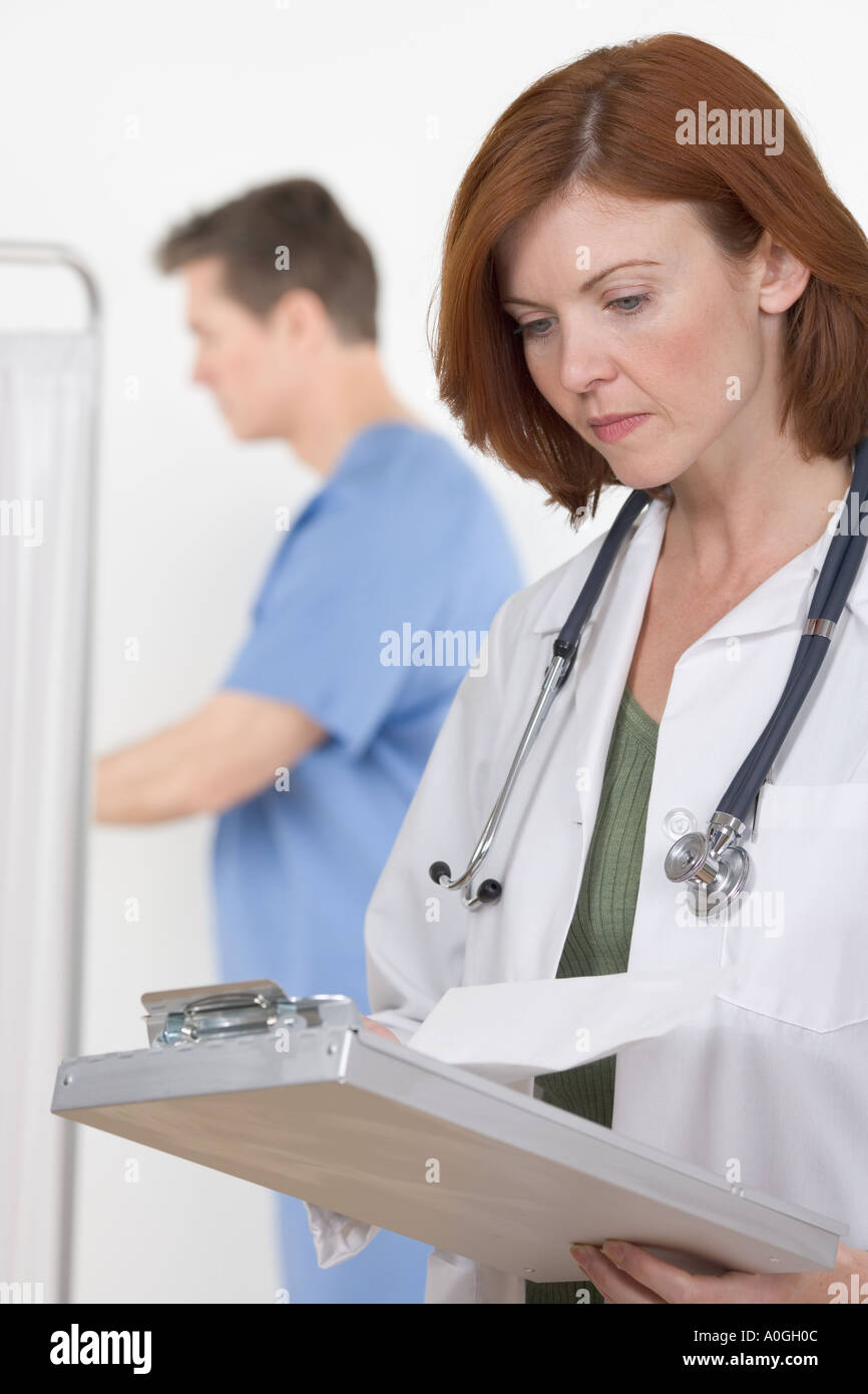 Female healthcare professional consulting chart Stock Photo