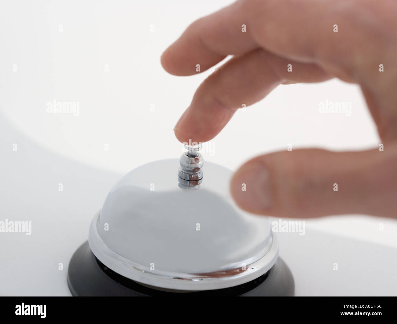 Closeup of hand ringing desk bell Stock Photo