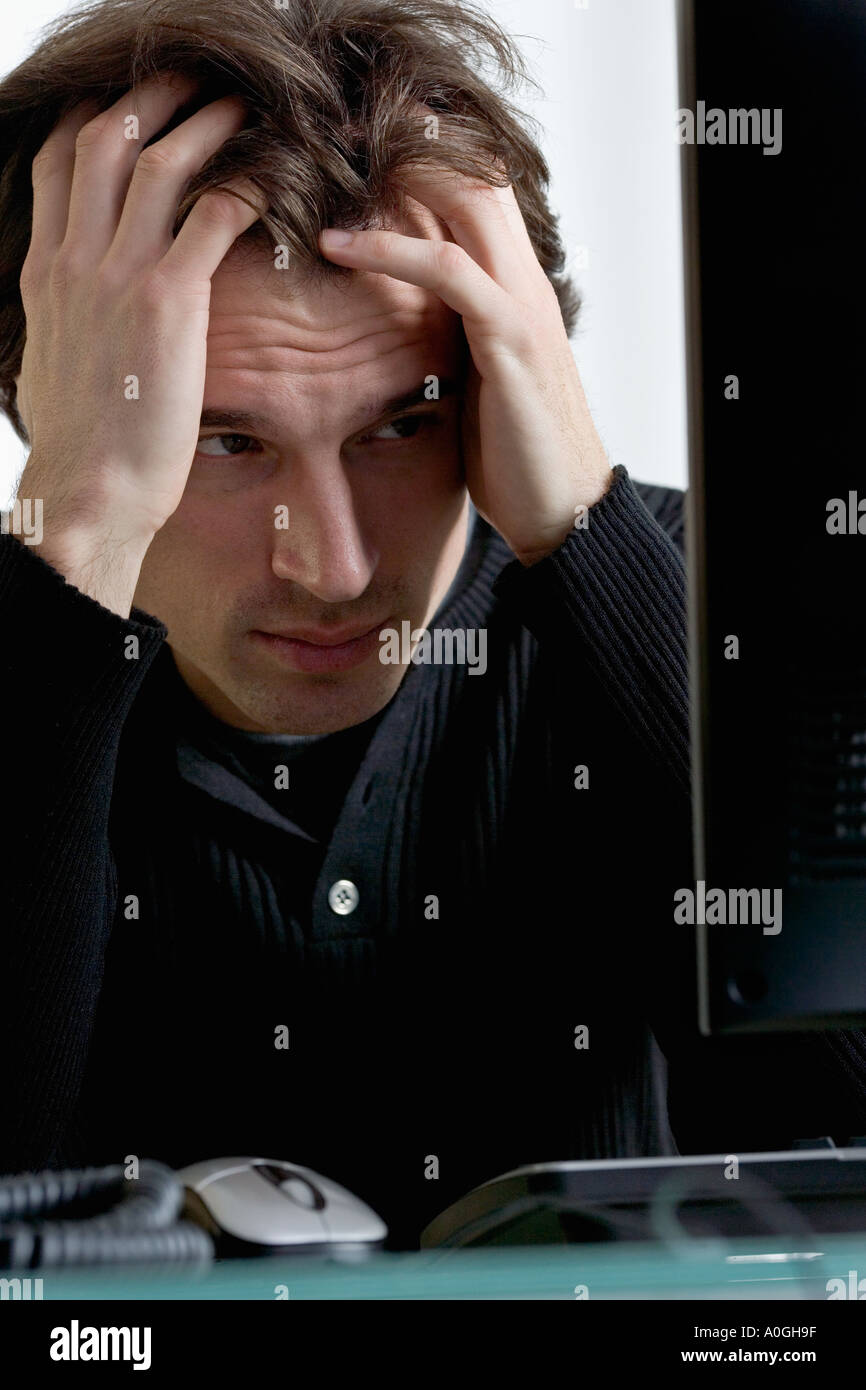 Closeup of distressed man with computer Stock Photo