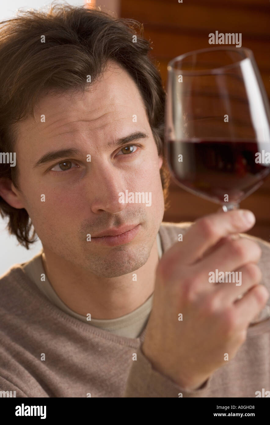 Closeup of man examining red wine Stock Photo