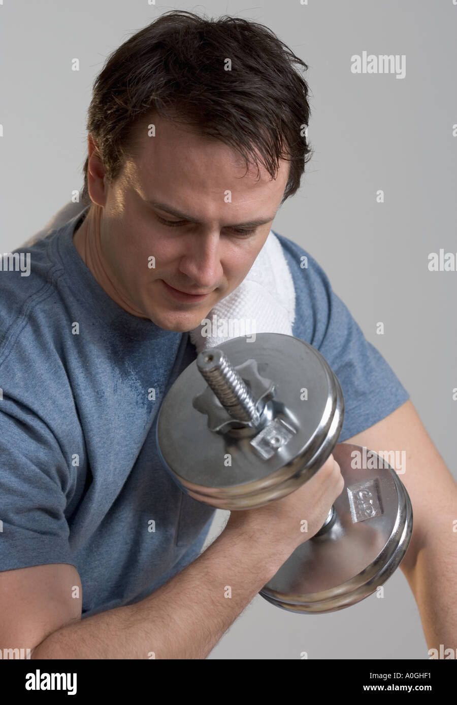 Sweating man lifting weights Stock Photo Alamy