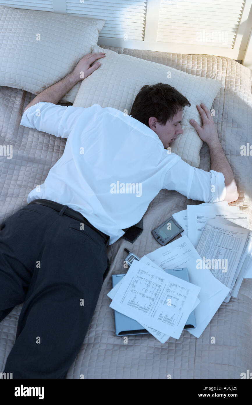 Overworked businessman sleeping with paperwork Stock Photo