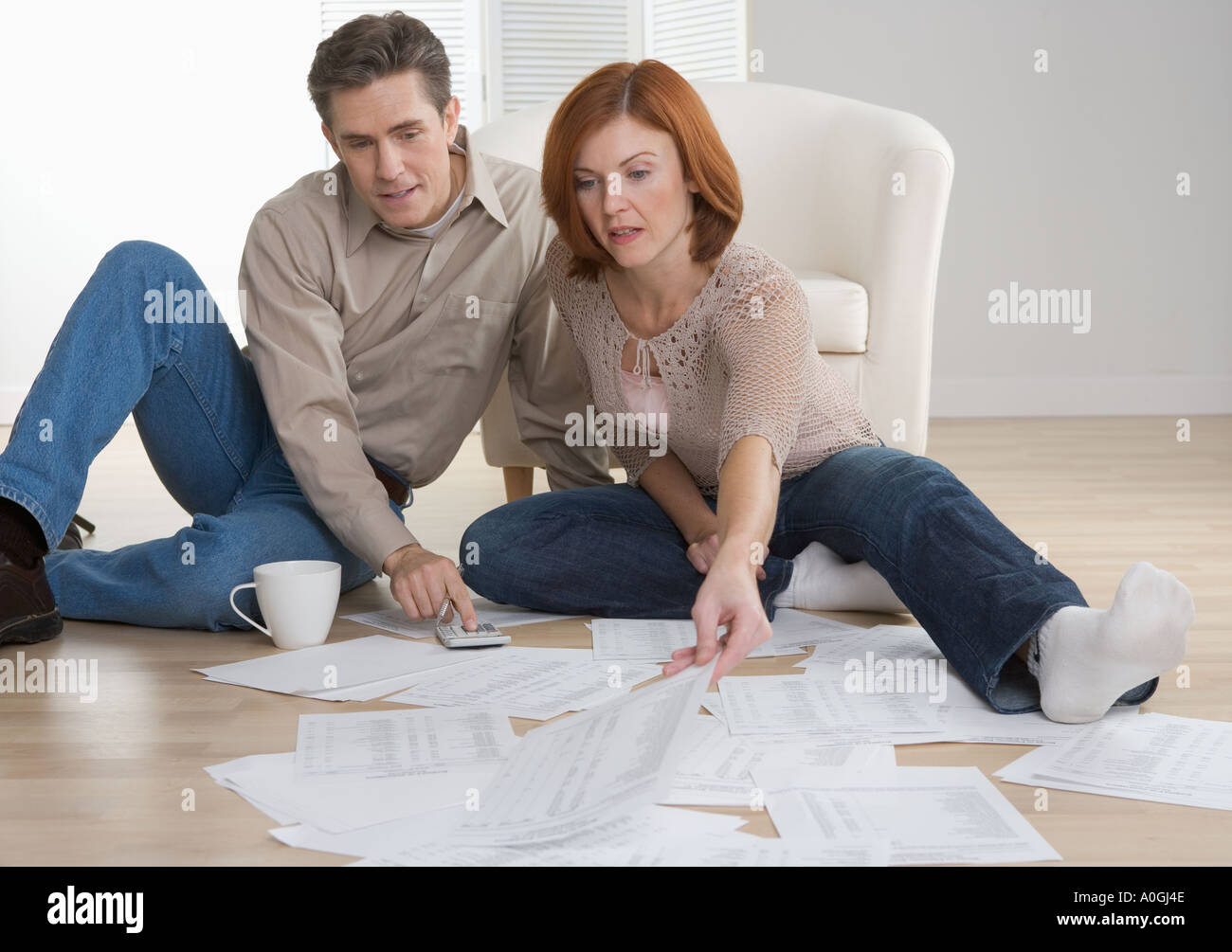 Couple with paperwork on floor Stock Photo