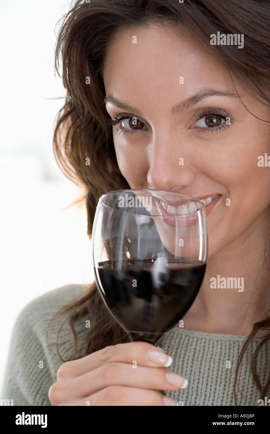 Smiling woman drinking red wine Stock Photo