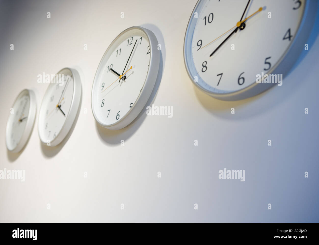 Closeup of clocks telling different times Stock Photo - Alamy