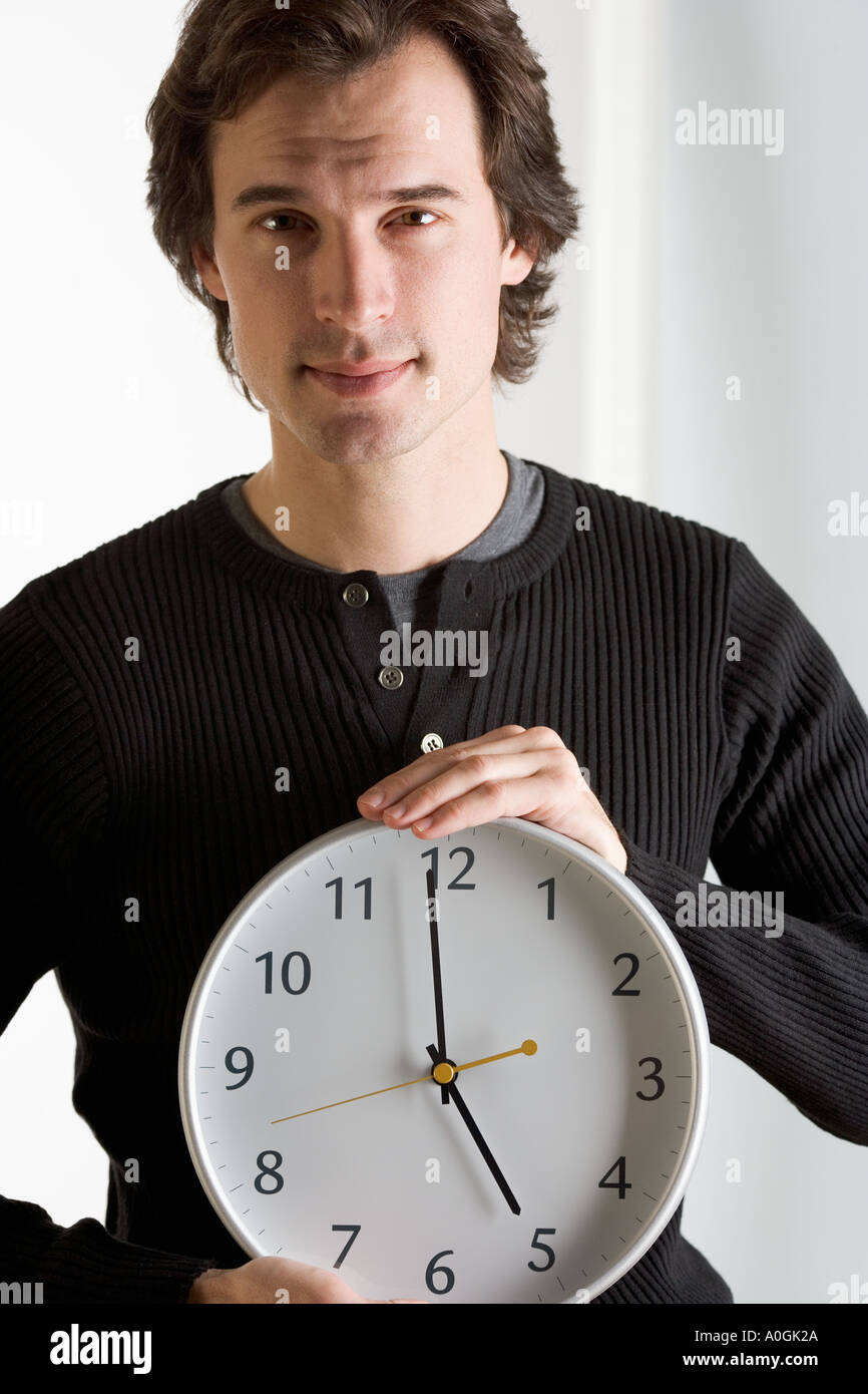 Closeup of man with clock Stock Photo