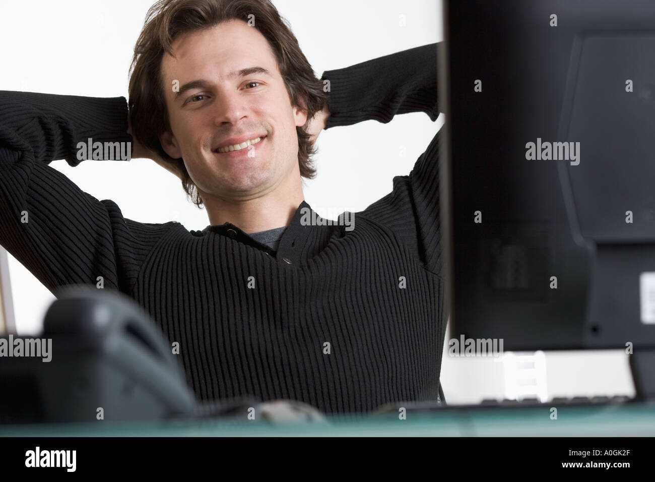 Smiling man at desk with computer Stock Photo