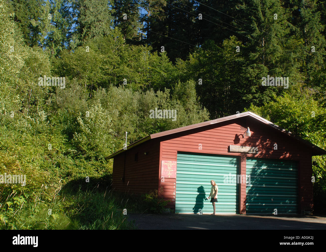 Girl Next To Fire Station Lake Quinault Washington Stock Photo