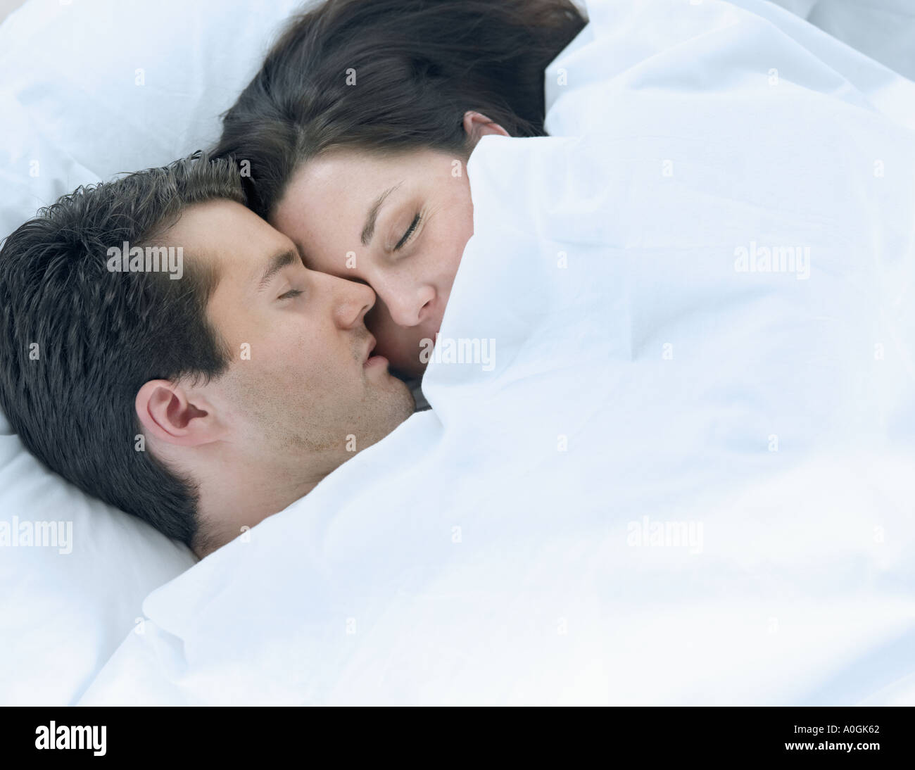 Couple asleep in bed Stock Photo