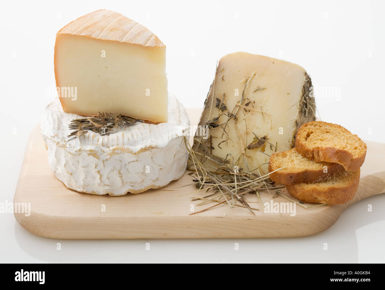 Cheeses on cutting board Stock Photo