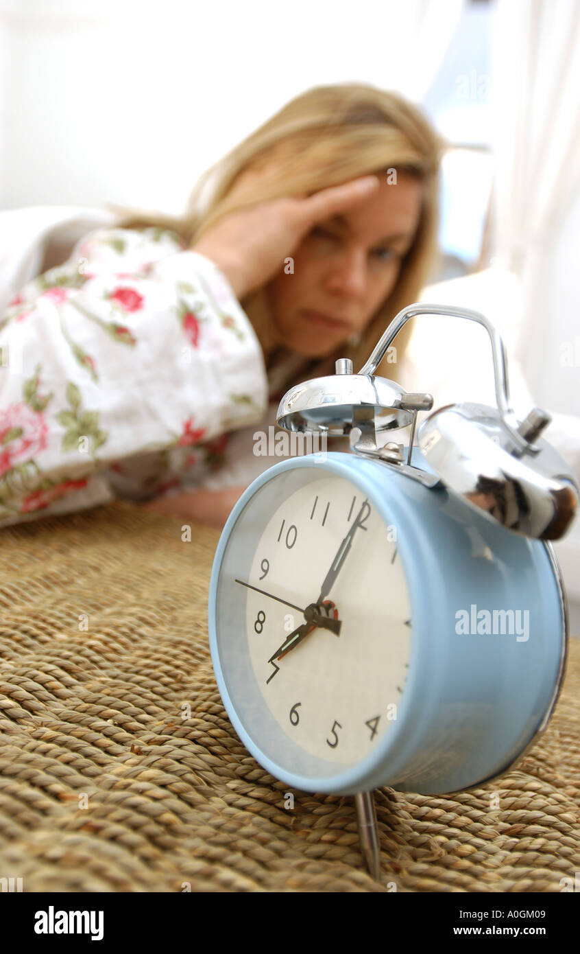 woman awake to alarm clock Stock Photo Alamy