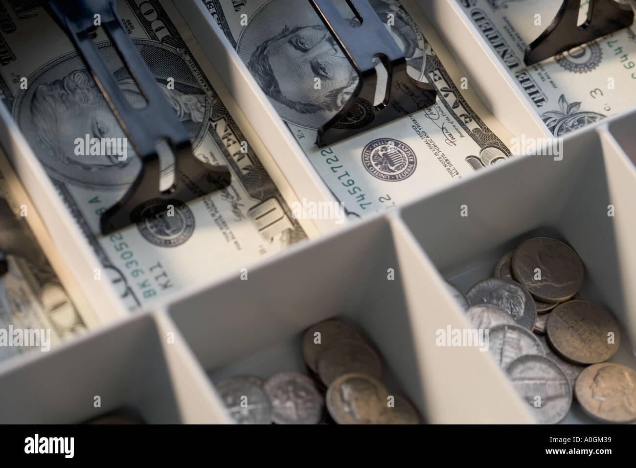 U S bills and coins in cash register Stock Photo