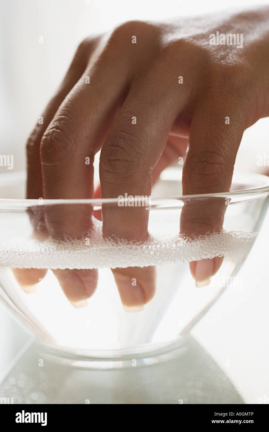 Soaking fingernails Stock Photo