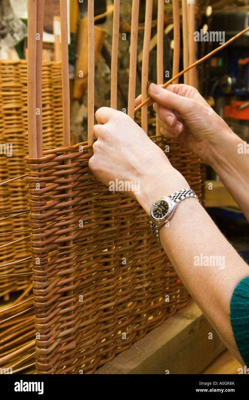 close up woman's hands weaving with willow Stock Photo
