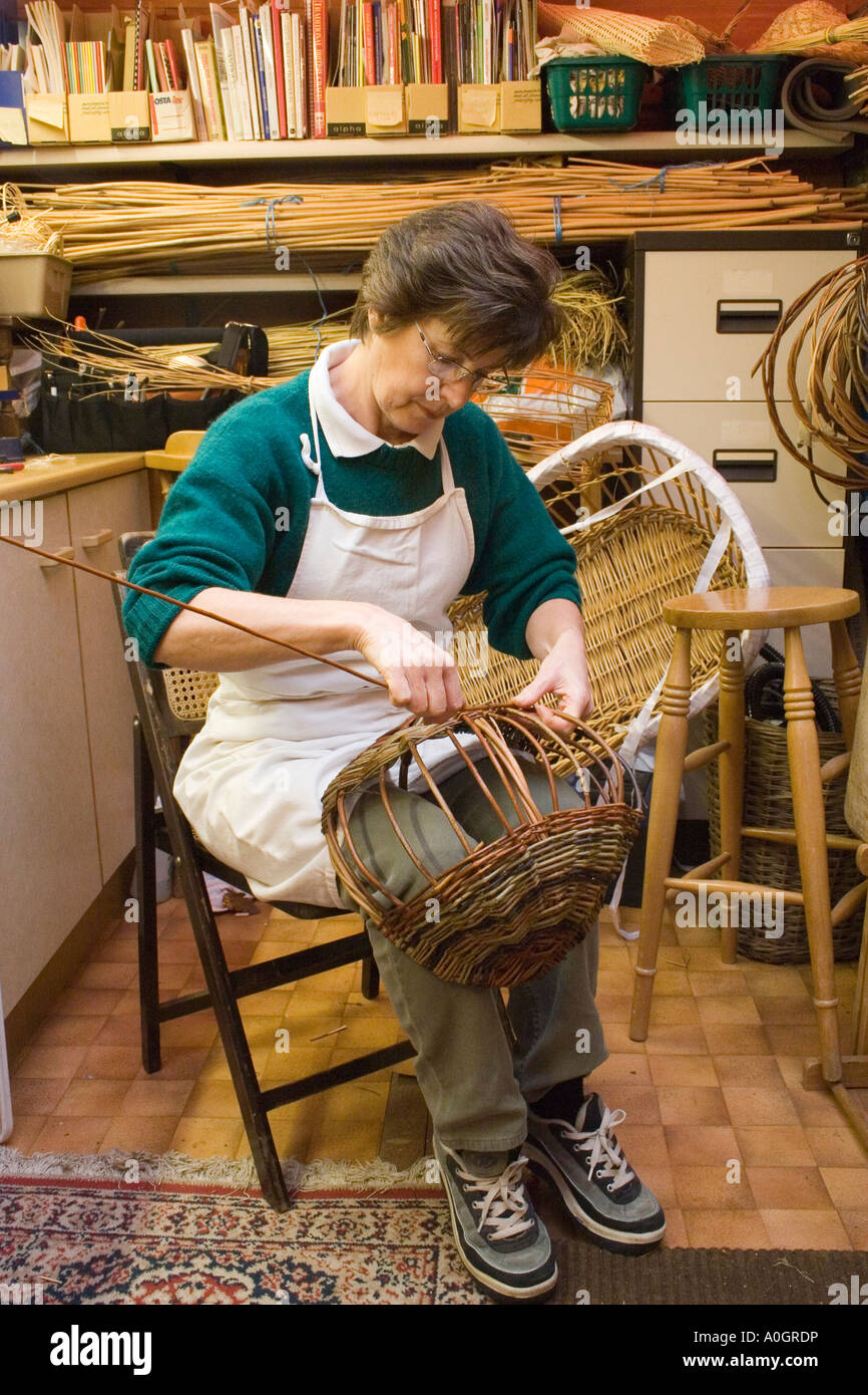 woman in her workshop making wicker basket Stock Photo