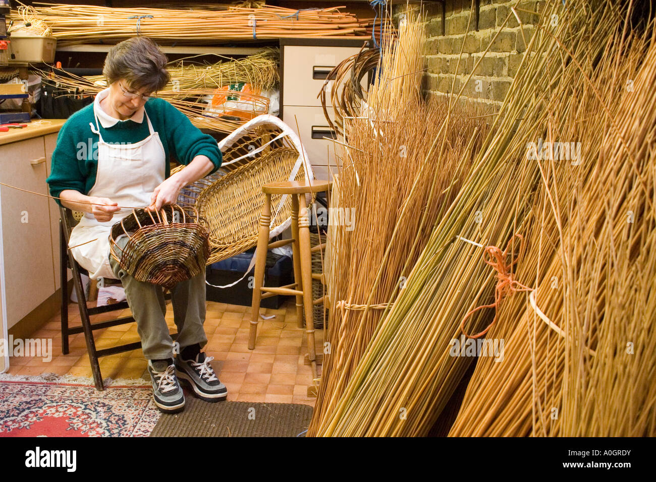woman in her workshop making willow basket Stock Photo