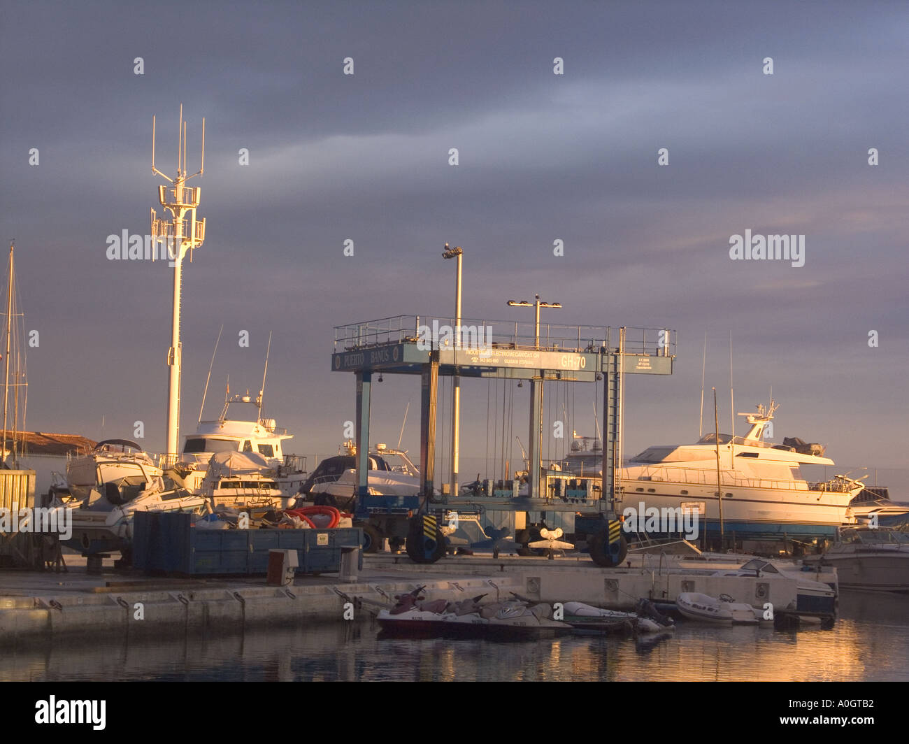Puerto Banus, Costa del Sol , Spain, dusk evening light boatyard boatyards sunset sunsets buildings playground of the rich yacht Stock Photo
