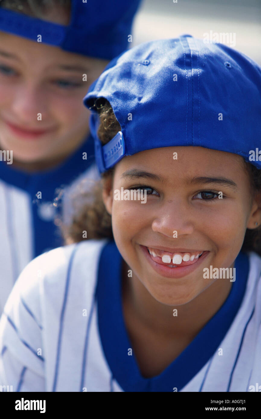Portrait of two girls in baseball uniforms smiling Stock Photo Alamy