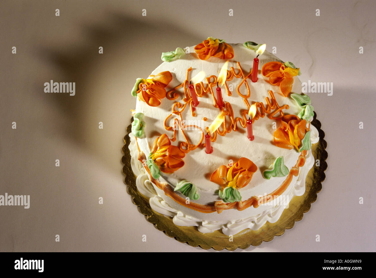Decorated birthday cake with lit candles Stock Photo - Alamy