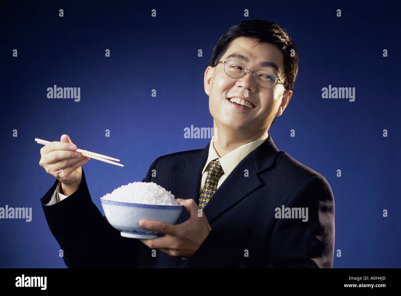 Smiling man with a bowl of rice hi-res stock photography and images - Alamy