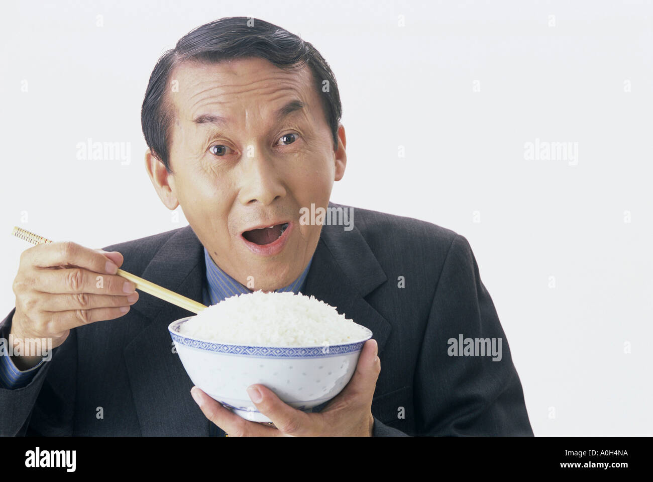 Portrait Of Man Holding A Bowl Of Rice Stock Photo Alamy