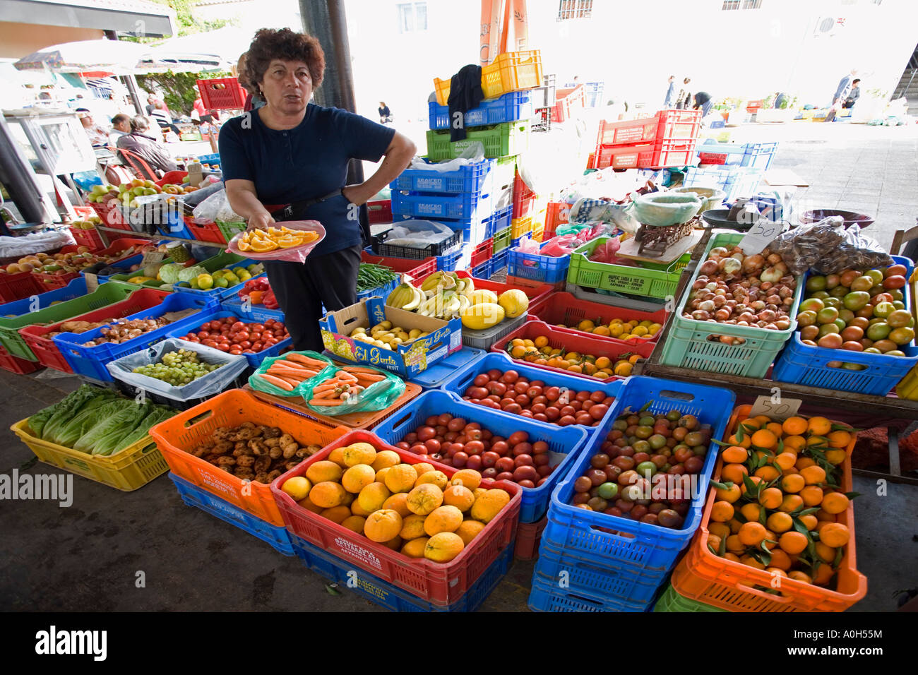LOCAL WOMEN DRESSED IN  BLACK CLOTHES WAIT FOR CUSTOMERS AT THE OLD MARKET IN PAPHOS, CYPRUS Stock Photo