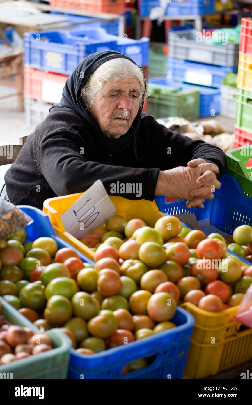A LOCAL WOMAN IN TRADITIONAL BLACK, AT THE MARKET IN THE TOWN CENTRE OF OLD PAPHOS, CYPRUS Stock Photo