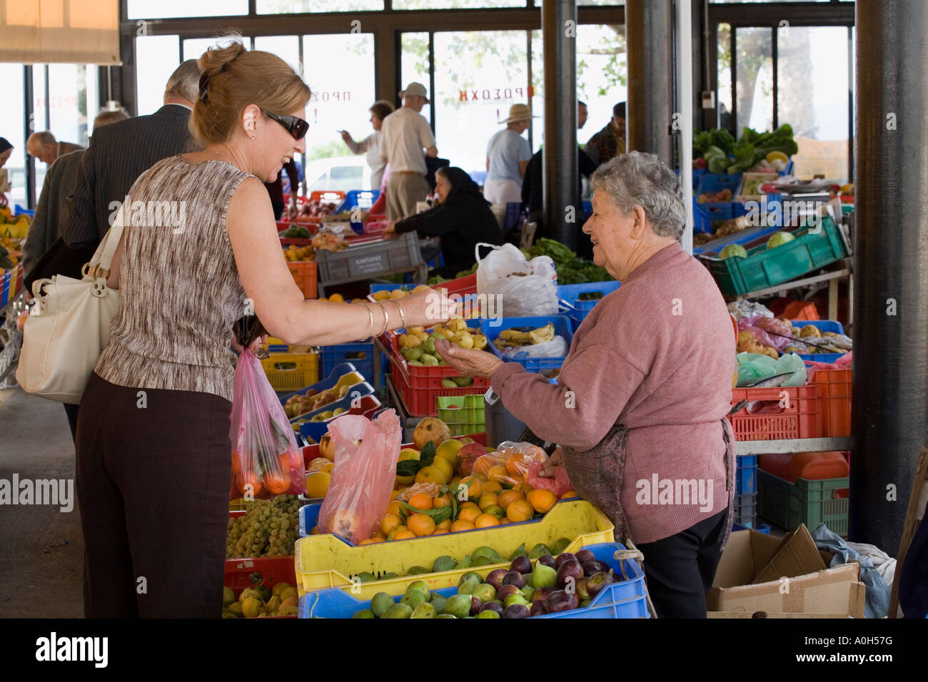SHOPPERS AT THE LOCAL MARKET IN THE TOWN CENTRE OF OLD PAPHOS, CYPRUS. Stock Photo