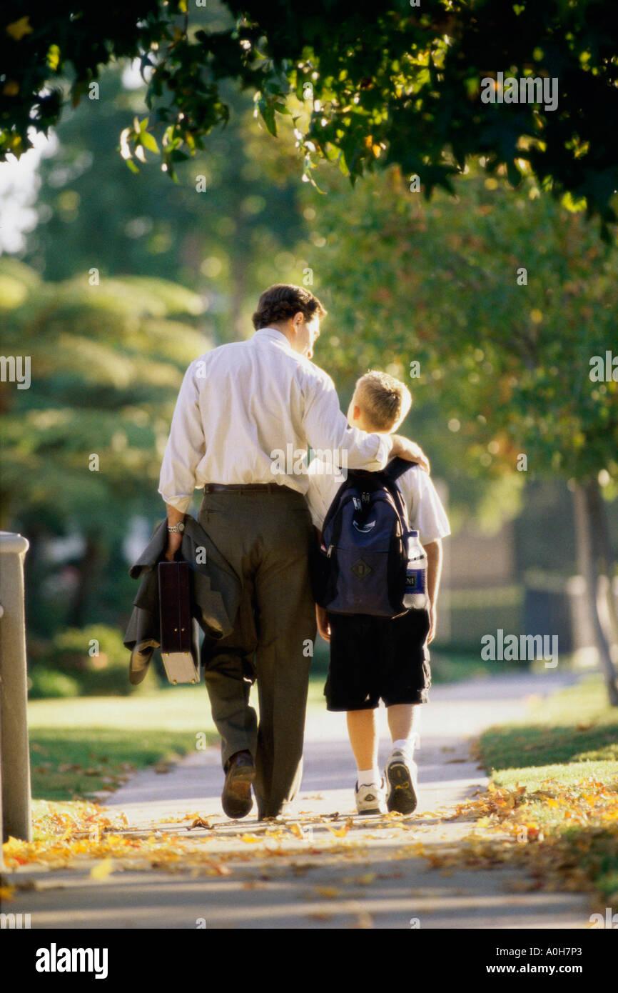 Rear view of a father walking with his son Stock Photo - Alamy