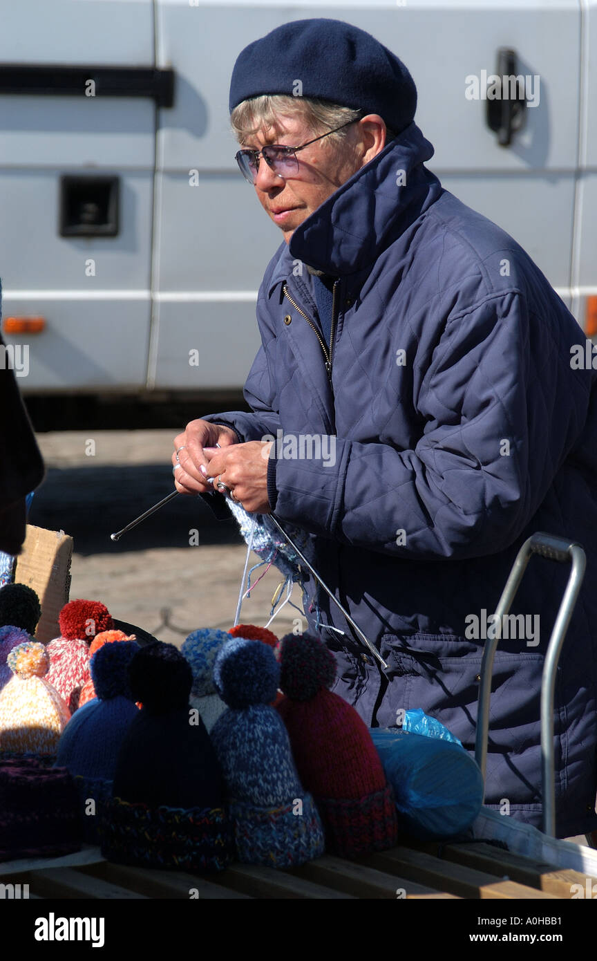 Woman knitting and selling hats at the Kauppatori Helsinki Finland Stock Photo