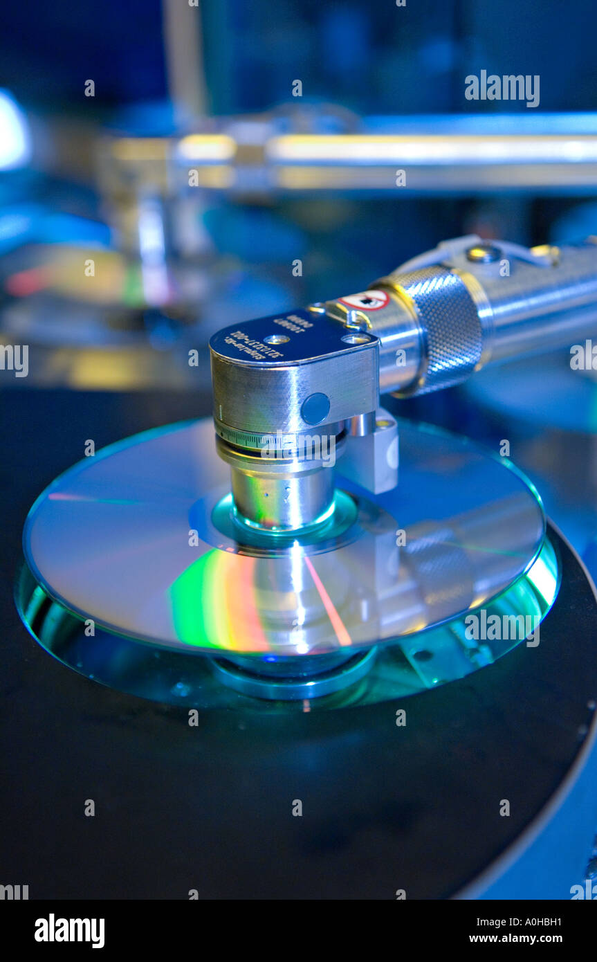 Reflective coating being applied to DVDs Stock Photo