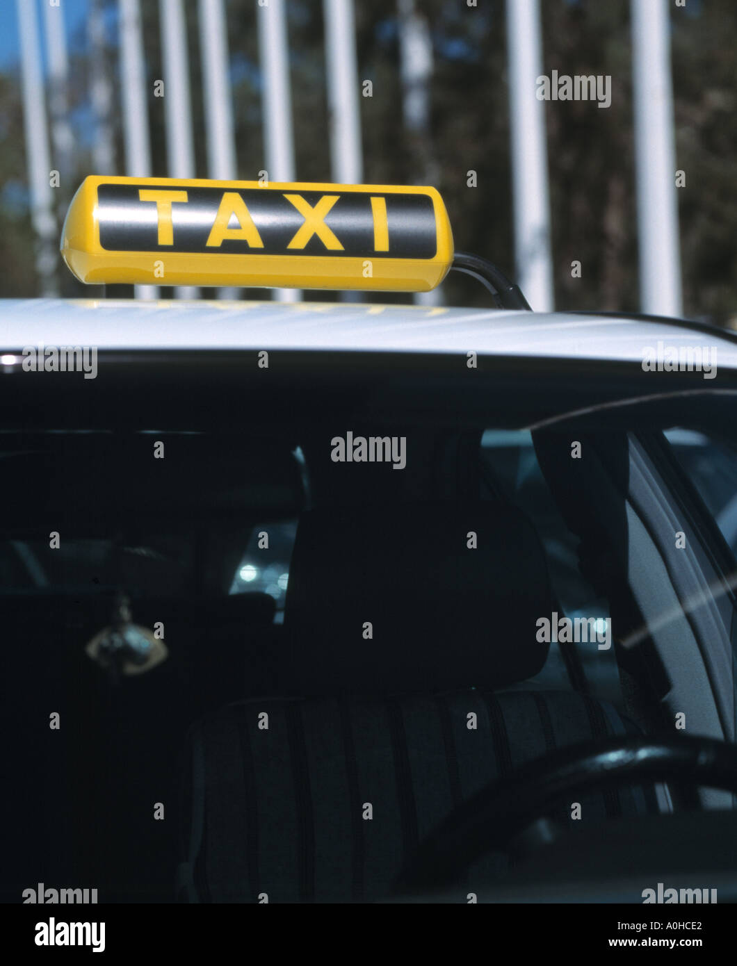 Sign and and drivers seat of empty greek taxi waiting on rank Rhodes