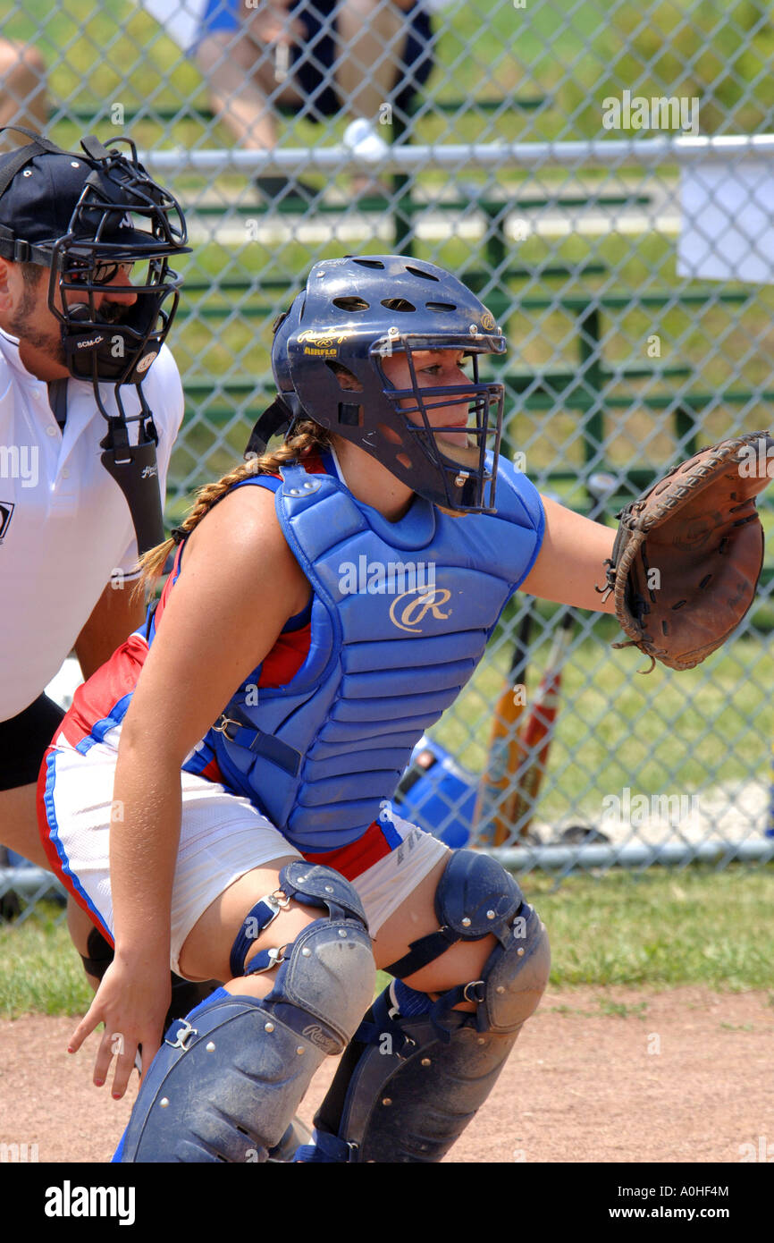 Teenage female Major League Softball player wearing the catcher's