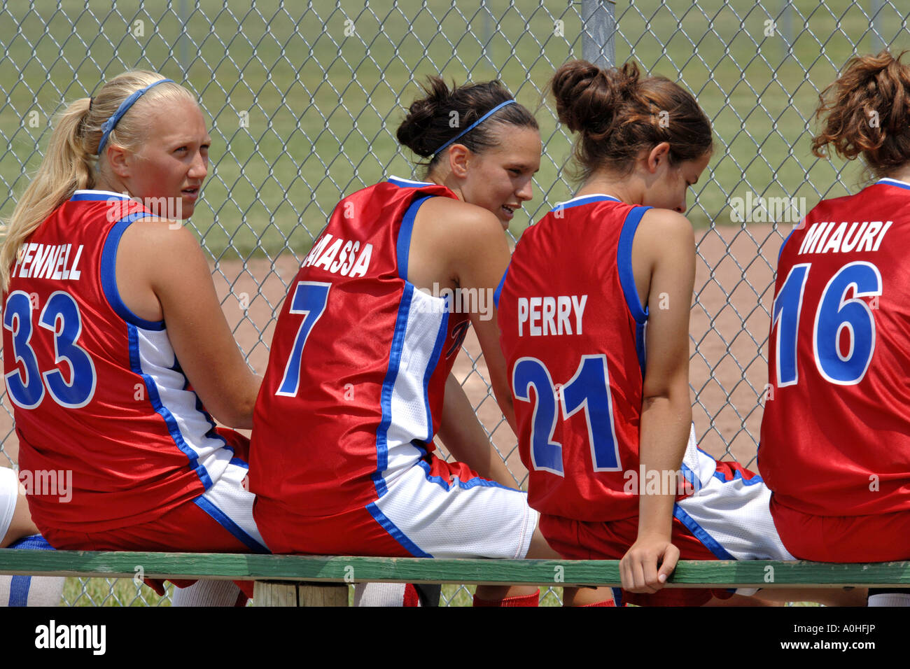 Teenage female Major league Softball players sitting on the bench Stock