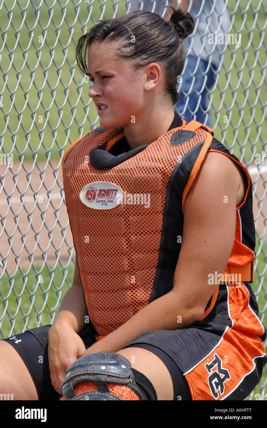 Teenage female major league Softball player sitting on the bench