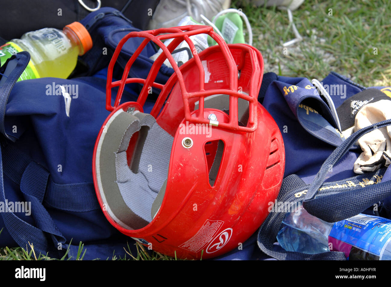 Red baseball helmet with face guard Stock Photo Alamy