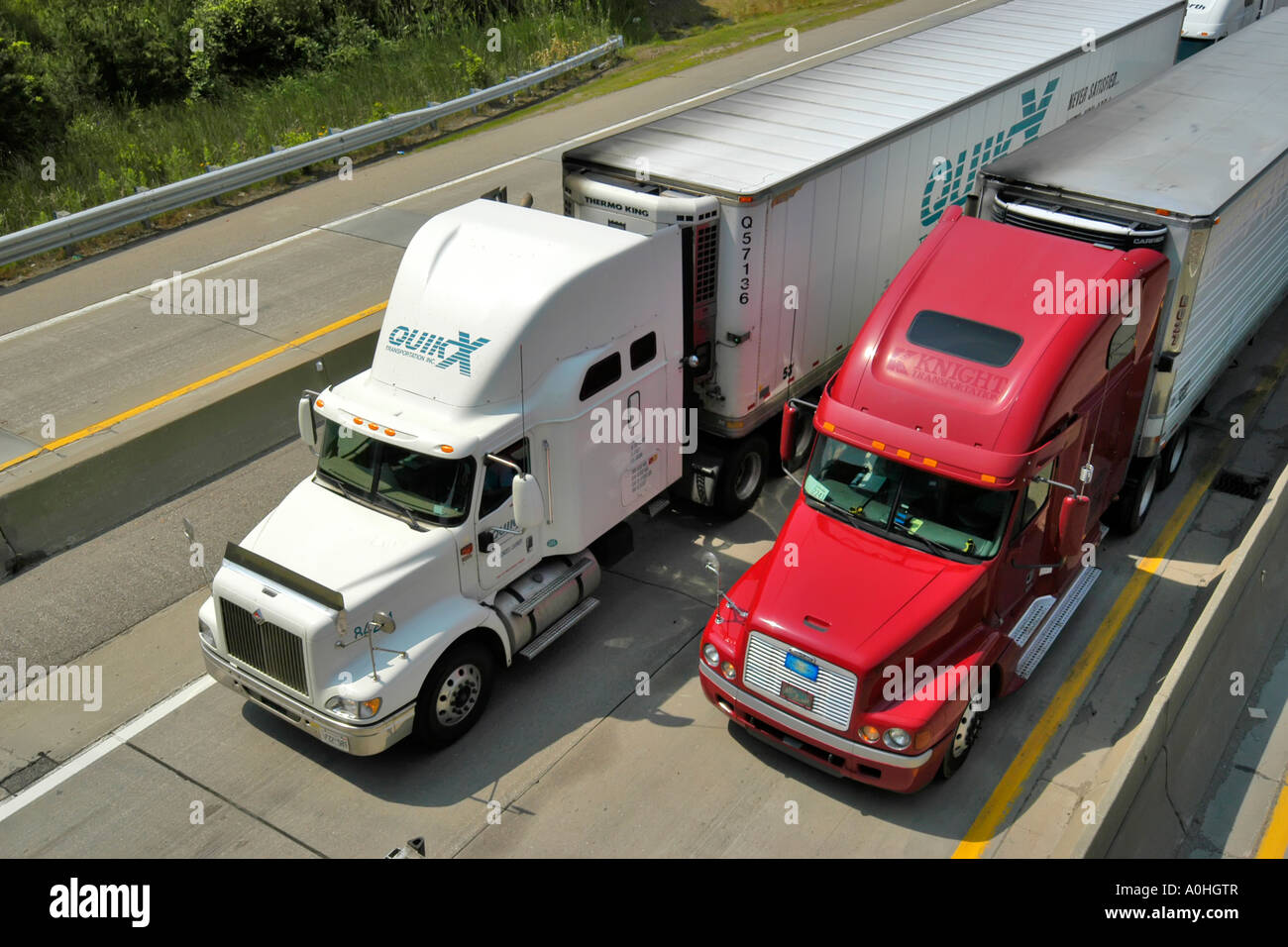 Two Lines of Semi Trucks on a Canadian Highway going to Michigan in the