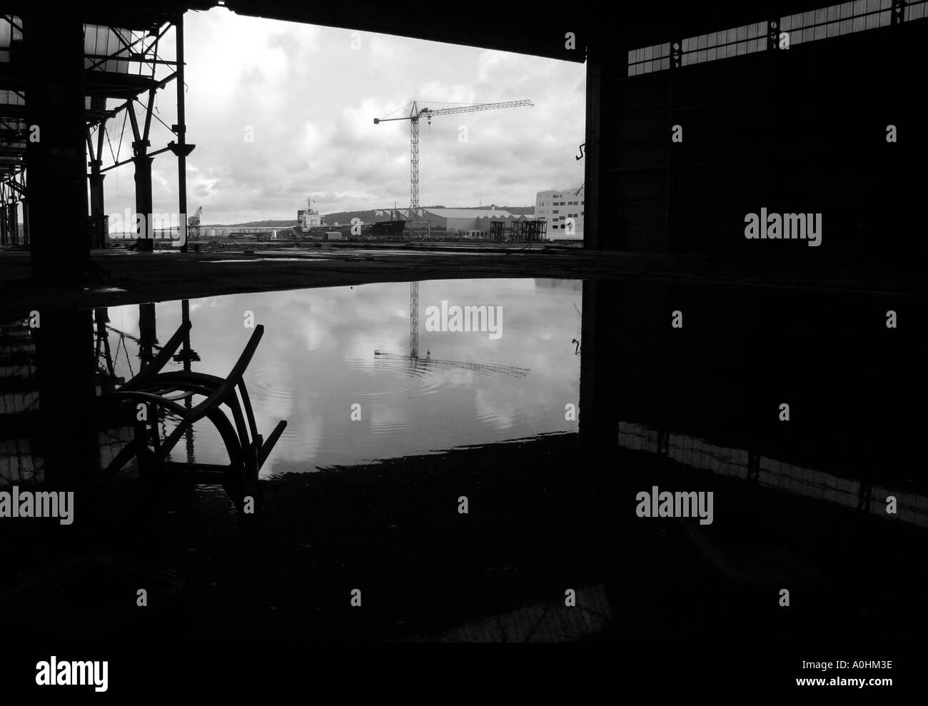 Looking out across Belfast docks from a disused factory Stock Photo