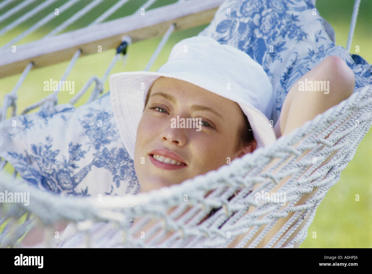 Portrait of a young woman lying in a hammock Stock Photo - Alamy