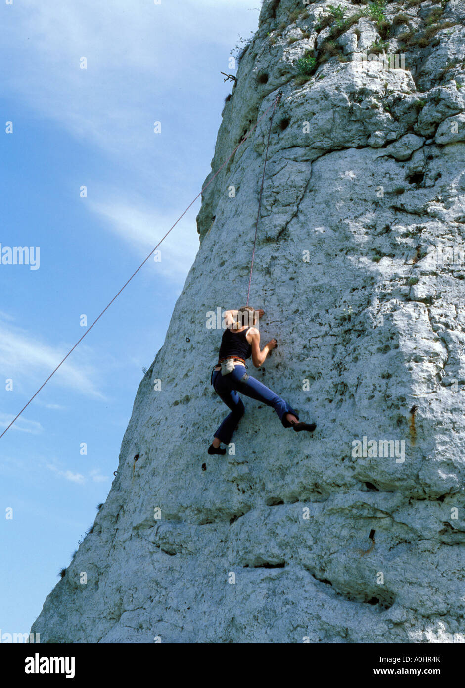 Man climbing on rock Stock Photo - Alamy
