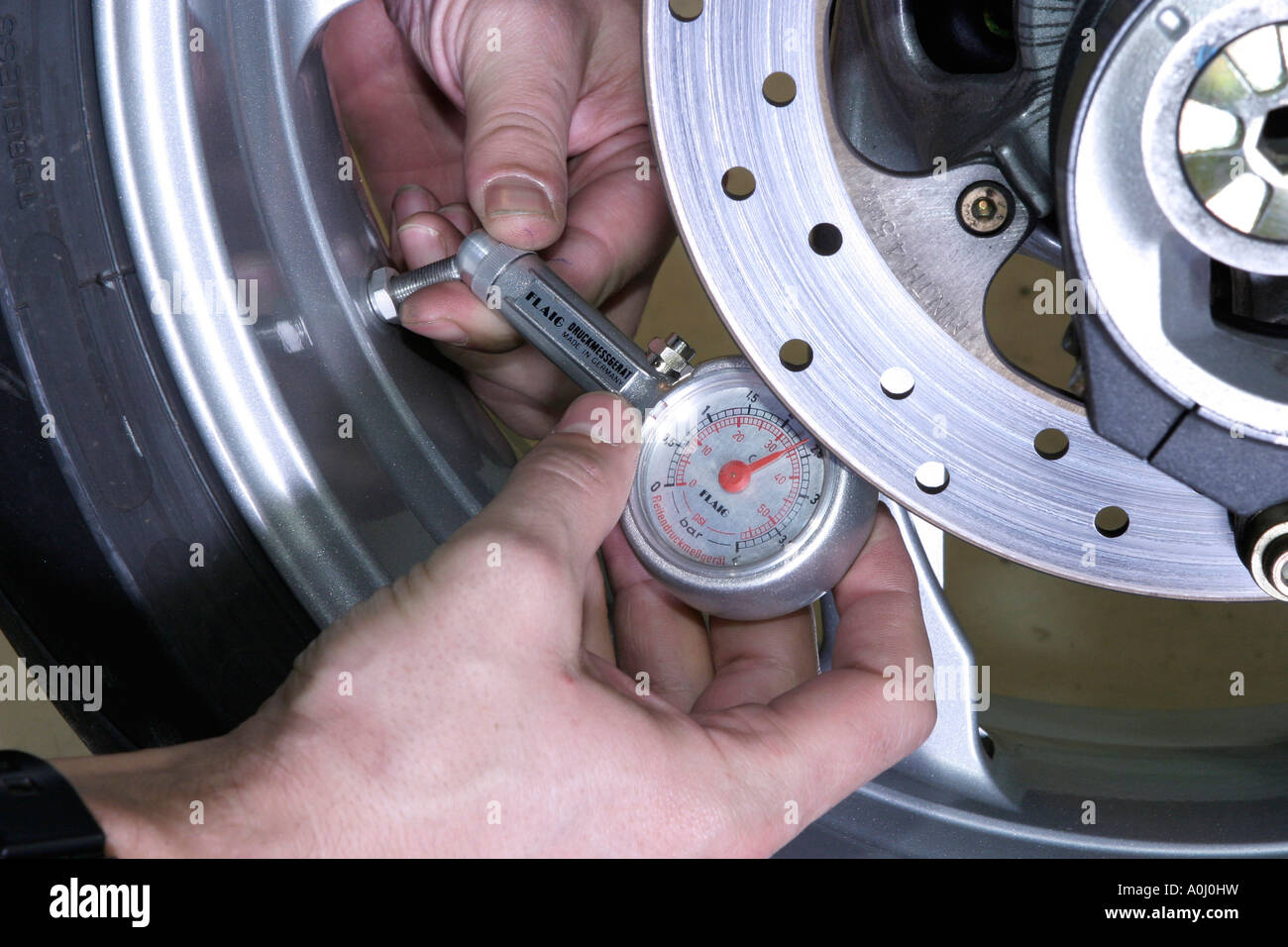 Measuring the pressure of a tyre hires stock photography and images